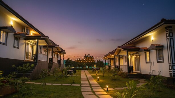 A two-story building with a covered outdoor area, a paved pathway, and string lights. - FabHotel Vagator Retreat Resort With Swimming Pool - Nr. Chapora Fort (Vagator)