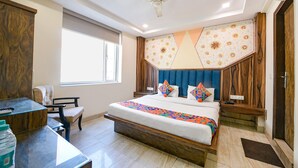 A bedroom with a bed, a desk, and a chair. - FabHotel Baba Residency (New Delhi)