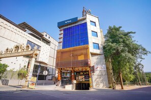 A hotel with a modern facade, a sign for 'Hotel Shreyas,' and a 'Via' sign on top. - Fabhotel Shreyas Inn (Bengaluru)