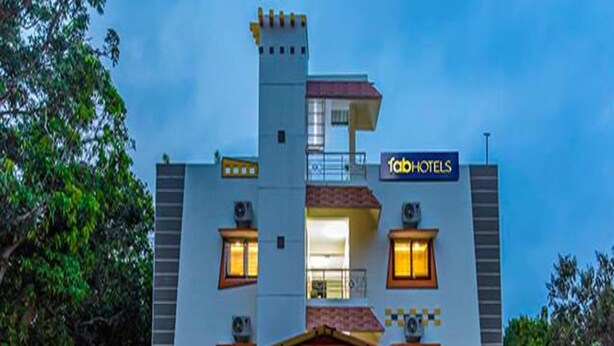 A hotel with a modern design, featuring a prominent entrance with a covered area and a signboard. - Fabescape Queens Paradise (Vanur)