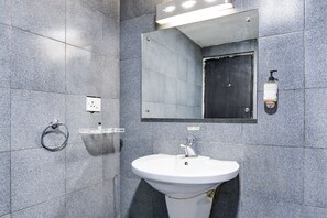 A modern bathroom with a white sink, a mirror, and a soap dispenser on the wall. - FabHotel Ballygunge Luxury - Behind Punjab Club (Kolkata)
