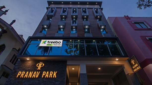 A hotel with a sign for 'treebo trend' and 'PRANAV PARK' indicating the name and location.