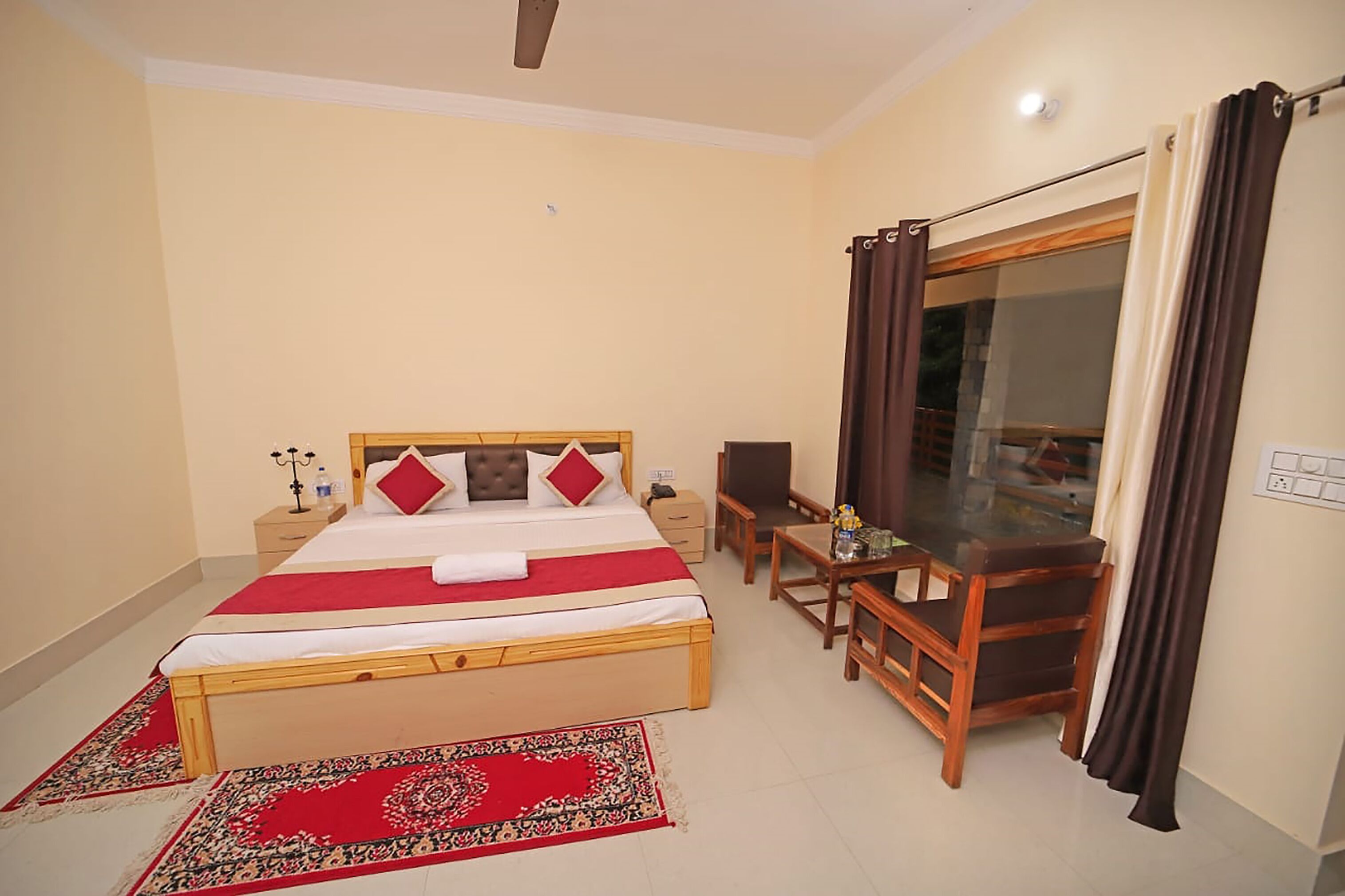 A bedroom with a bed, bedside table, and a desk with a chair.