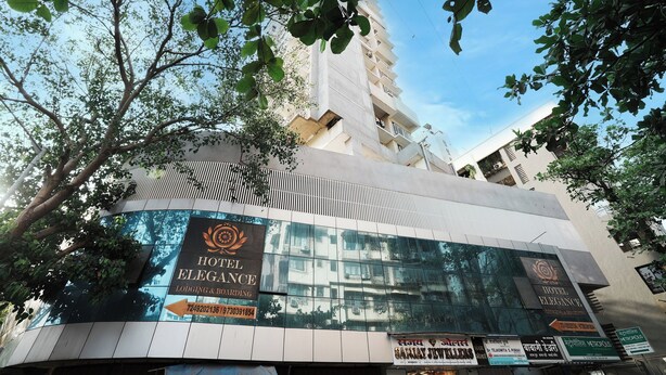 A hotel with a signboard advertising 'Hotel Elegance' and 'Lodging & Boarding'. - Hotel Elegance (Mumbai)