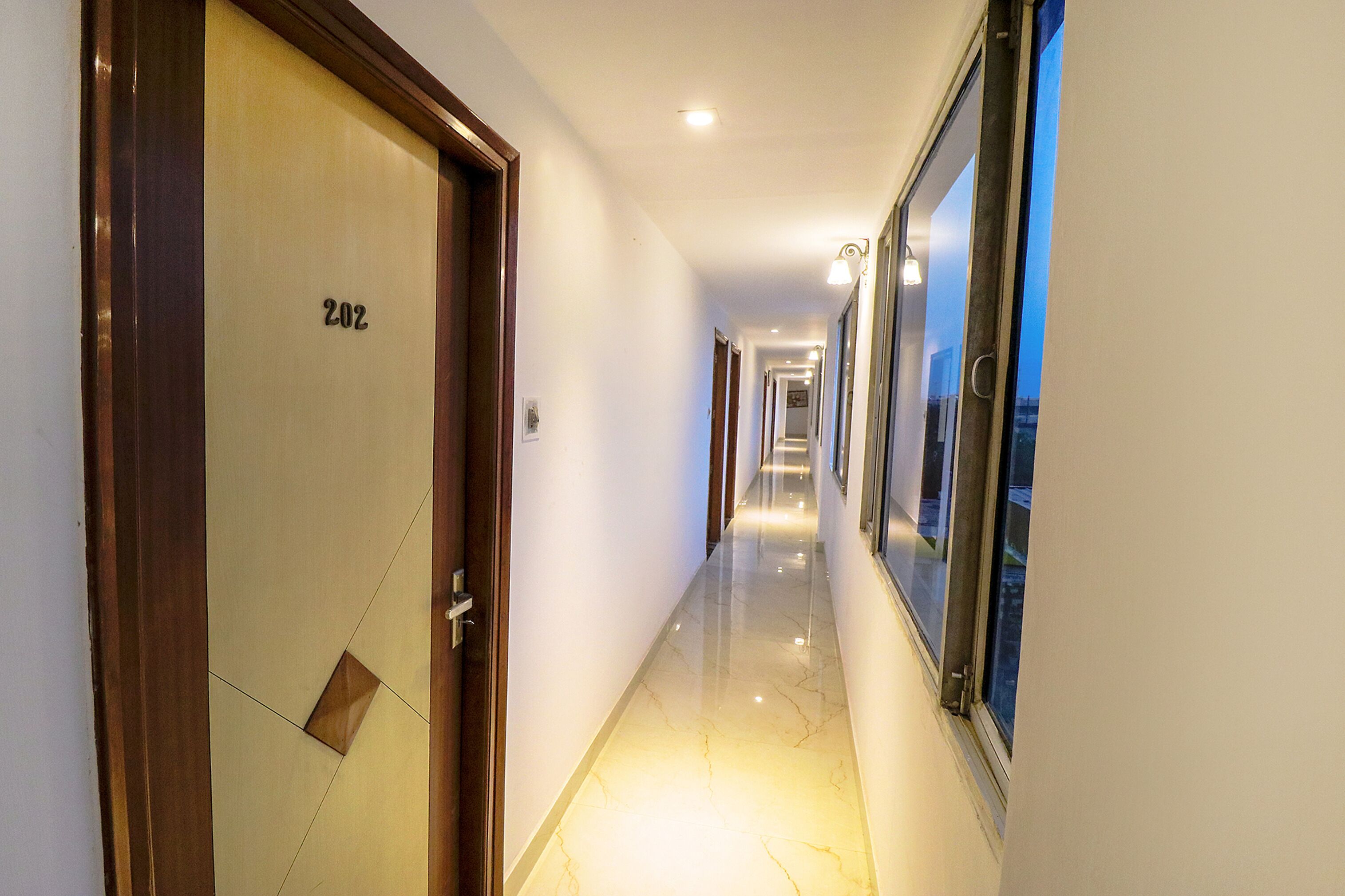 A corridor with a door labeled "202" and a window on the right.