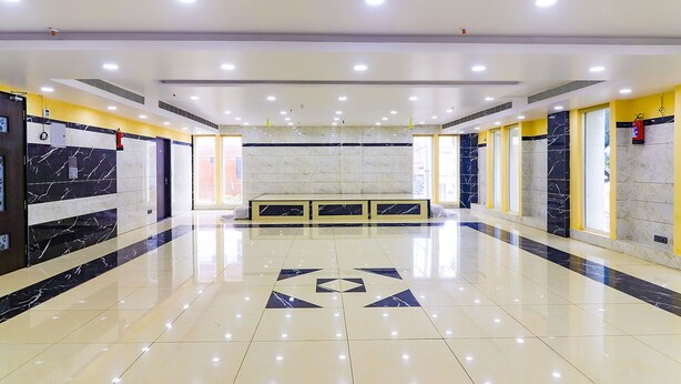 A spacious, well-lit lobby with a marble floor and a central seating area. - Fabhotel Surya Grand I (Vijayawada)