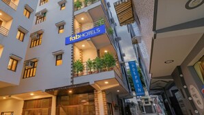 A multi-story hotel with balconies, a sign reading "fabHOTELS", and a street view. - FabHotel Dolphin International (New Delhi)