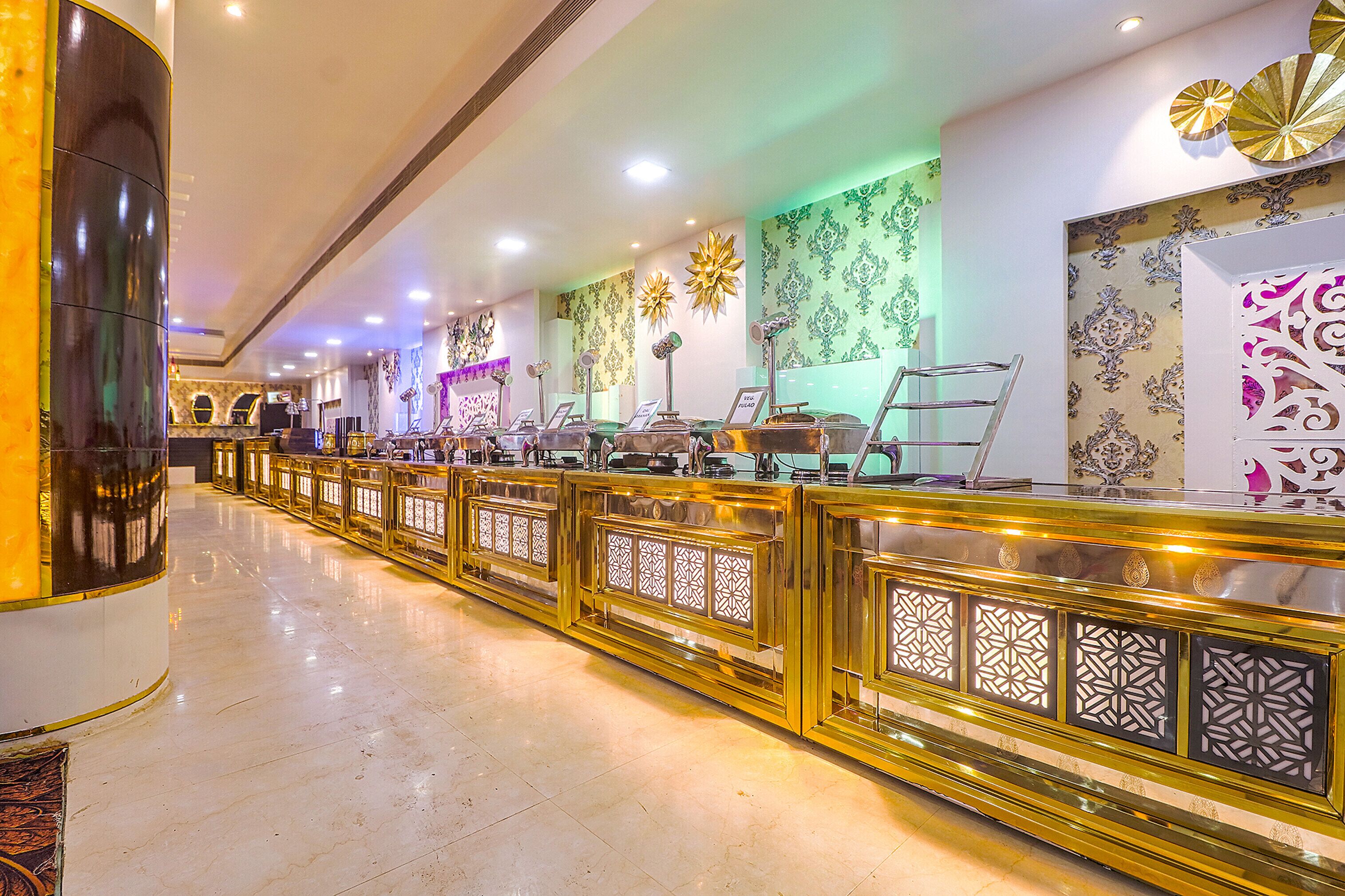 A hotel reception area with a long counter, decorative wall panels, and a modern design.