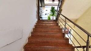 Eine Treppe mit Metallgeländern, die zu einer oberen Etage führt.