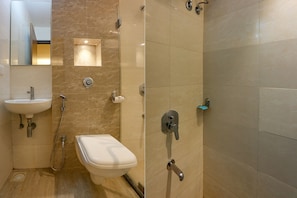 A bathroom with a sink, toilet, and shower. - Fabhotel Royal International (Mumbai)