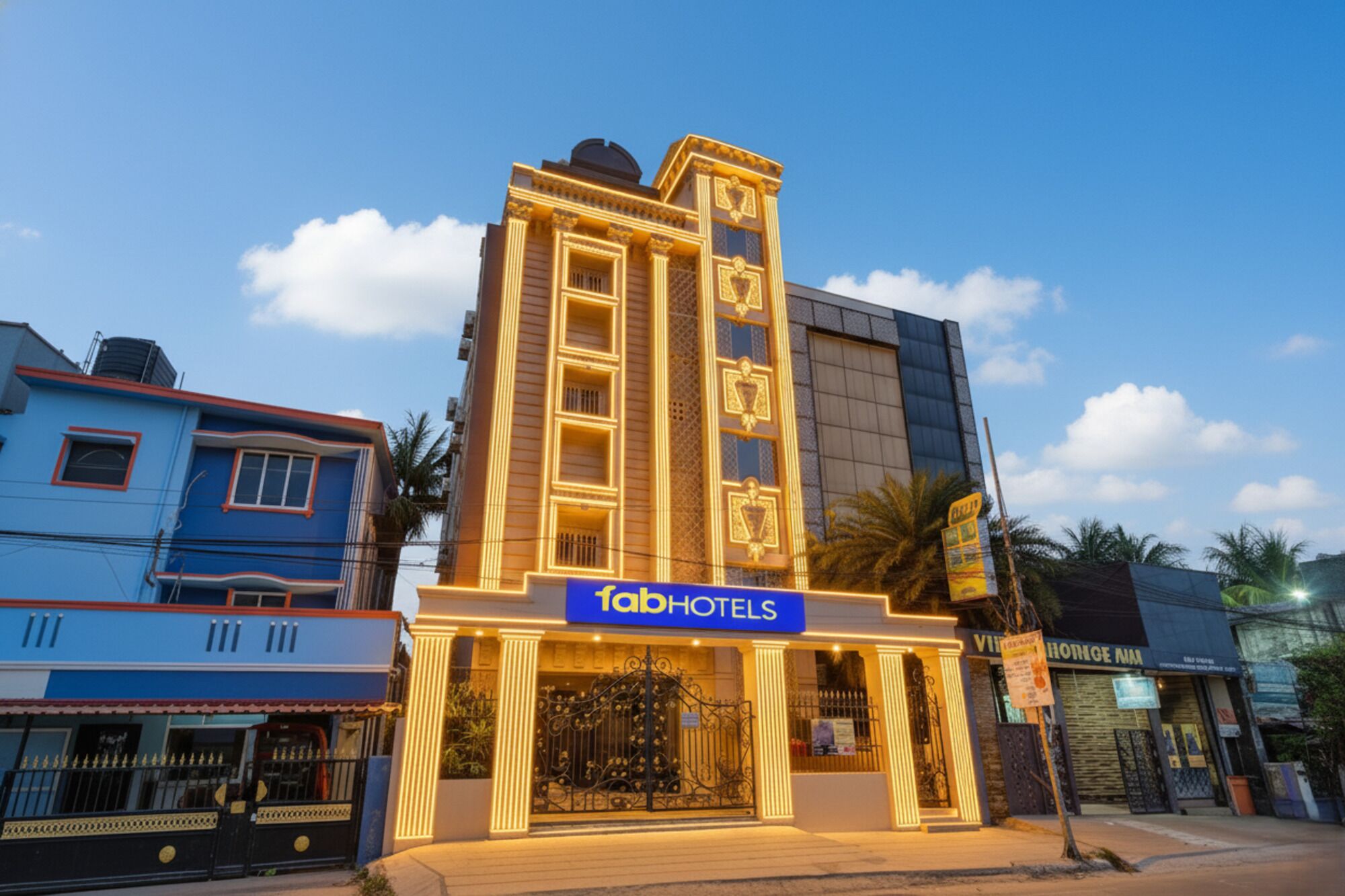 A hotel with a prominent sign, a central entrance, and a symmetrical facade.