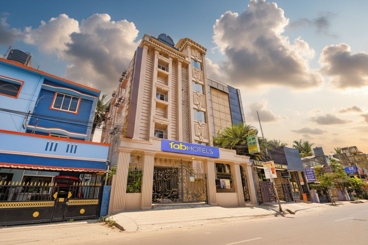 A hotel with a prominent sign, a gated entrance, and a traditional architectural style.