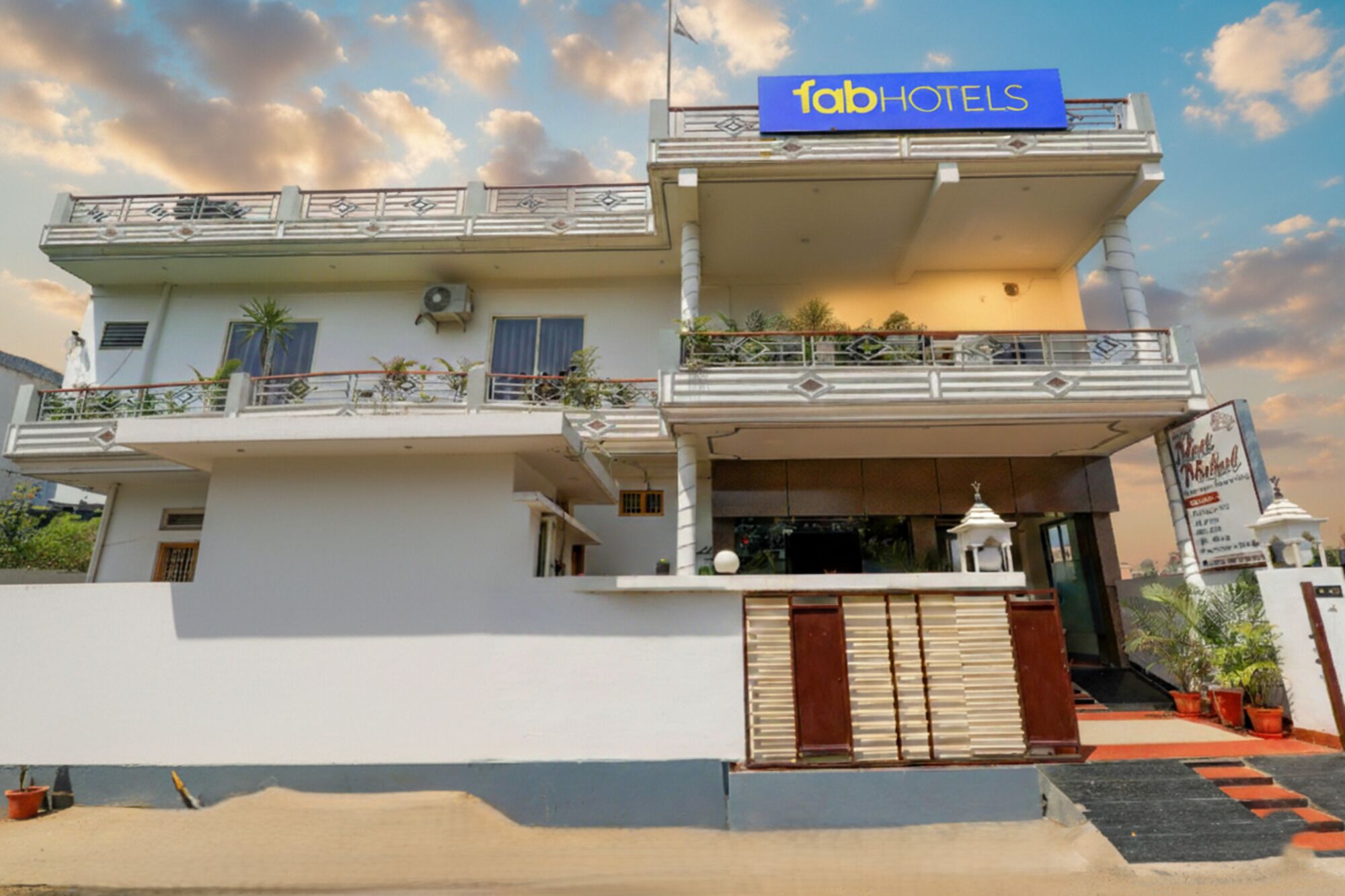 A two-story building with a sign reading "fab hotels".