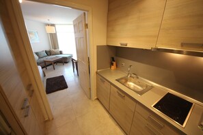 Fridge, stovetop, electric kettle, cookware/dishes/utensils