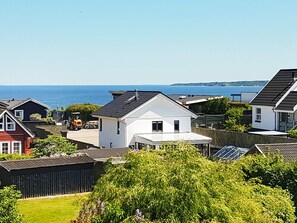 A residential area with houses, a clear sky, and a view of the sea. - 6 Person Holiday Home in Borkop (Borkop)