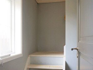 A room with a window, a door, and a set of wooden steps leading to a lower level. - 4 Star Holiday Home in Nassjo (Nassjo)