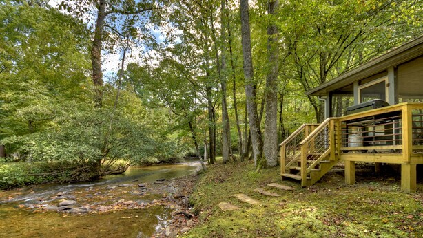 Unclassified image, 1 of 28, button - Laughing Waters- nestled along Fighting Town Creek, offering pet-friendly bliss with a hot tub, firepit, larege screened porch and excellent fishing. WiFi (Cherry Log)