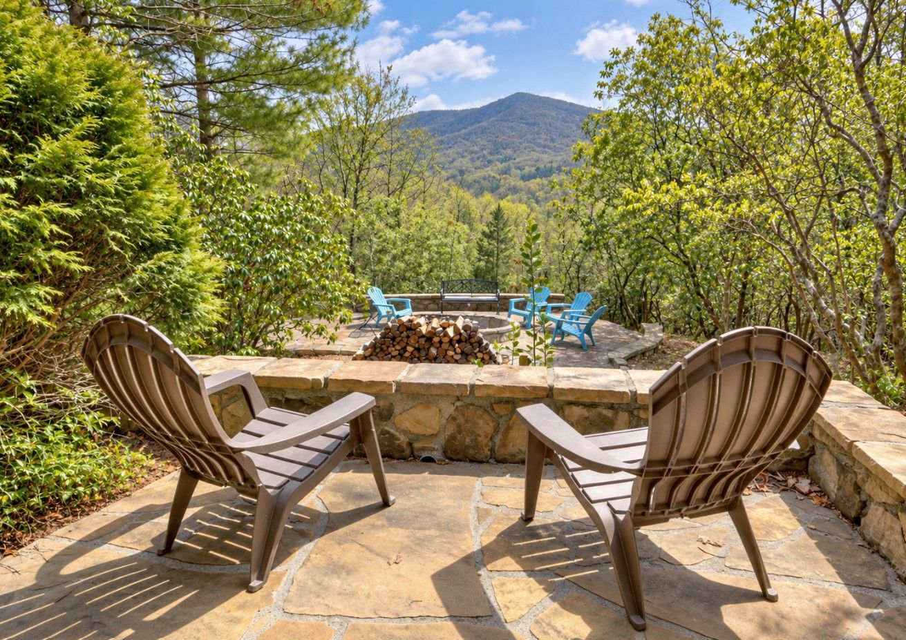 An outdoor seating area with two chairs and a fire pit.