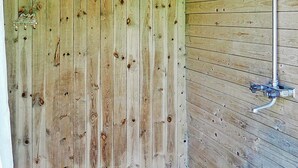 A wooden door with a metal handle and a metal pipe running vertically along the wall. - 6 Person Holiday Home in Hastveda (Hästveda)