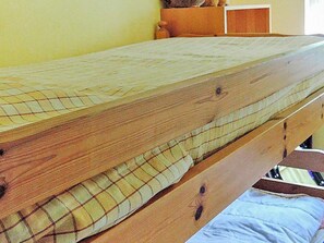 A wooden bed with a mattress and a pillow. - 6 Person Holiday Home in Hastveda (Hästveda)