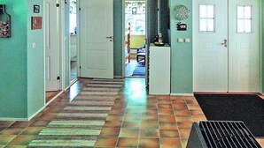 A hallway with a ceiling fan, a door with a window, and a rug leading to a room. - 6 Person Holiday Home in Hastveda (Hästveda)