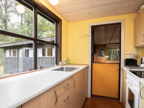 A compact kitchen with a window, a sink, and a stove. - 5 Person Holiday Home in Fjerritslev (Fjerritslev)