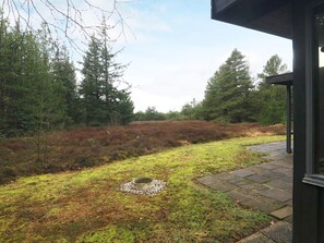 A grassy area with a concrete structure, surrounded by trees and a clear sky. - 5 Person Holiday Home in Fjerritslev (Fjerritslev)