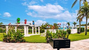 A gazebo with a white railing and a black mailbox in the foreground. - Private 1/1 Poolside Cottage! BBQ Grills, Near Beach & More! (Fort Myers)