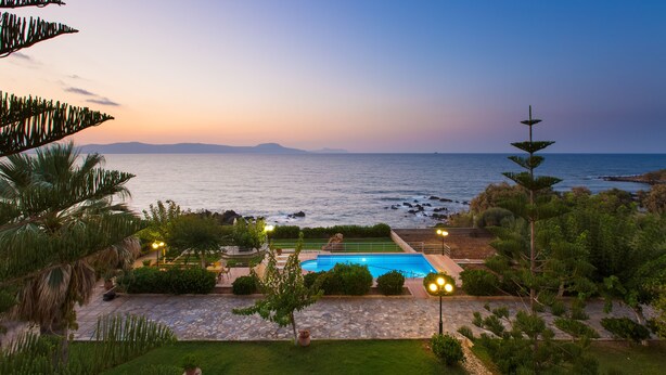 A pool area with a view of the ocean at dusk. - Seaside Family Villa for Weddings and Ceremonies (Rethymno)