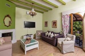 Villa, varias camas | Área de sala de estar