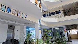 A multi-level atrium with a central water feature, multiple floors, and a staircase. - c3 Cowrie Shell Residences (Mombasa)
