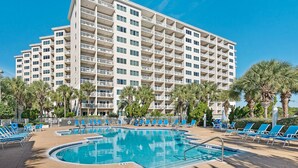 A hotel with multiple floors, a swimming pool, and palm trees. - Tops'l Summit 913 Great pool, hot tub, close to beach, private resort (Miramar Beach)