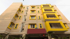 Un edificio de varios pisos con ventanas y balcones de marco amarillo.