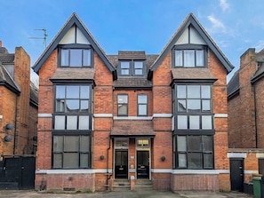 A two-story brick building with large windows and a central entrance. - Amber Suite Moseley Birmingham STAE-Homes (Birmingham)