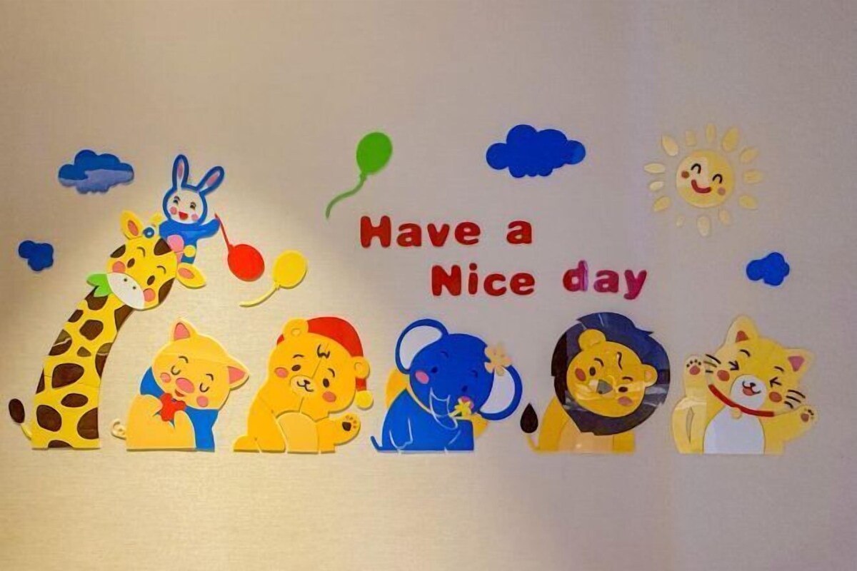 A wall with cut-out animal figures and a 'Have a Nice day' message.