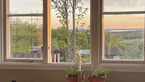 A table with a candle, two potted plants, and a dish. - 4 Person Holiday Home in Undenas-by Traum (Undenäs)