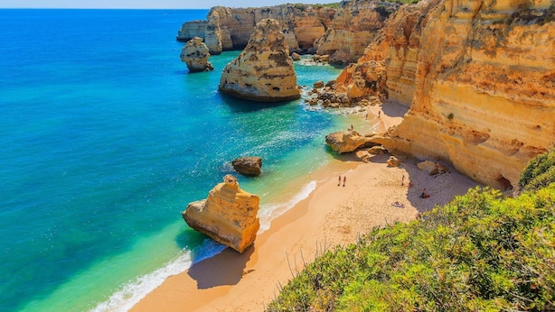 A coastal landscape with cliffs, clear blue sea, and a sandy beach. - B13 - Patio Apartment in Casa Feliz (Lagos)