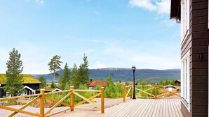 A wooden deck with a view of mountains and trees. - 10 Person Holiday Home in Salen-by Traum (Salen)