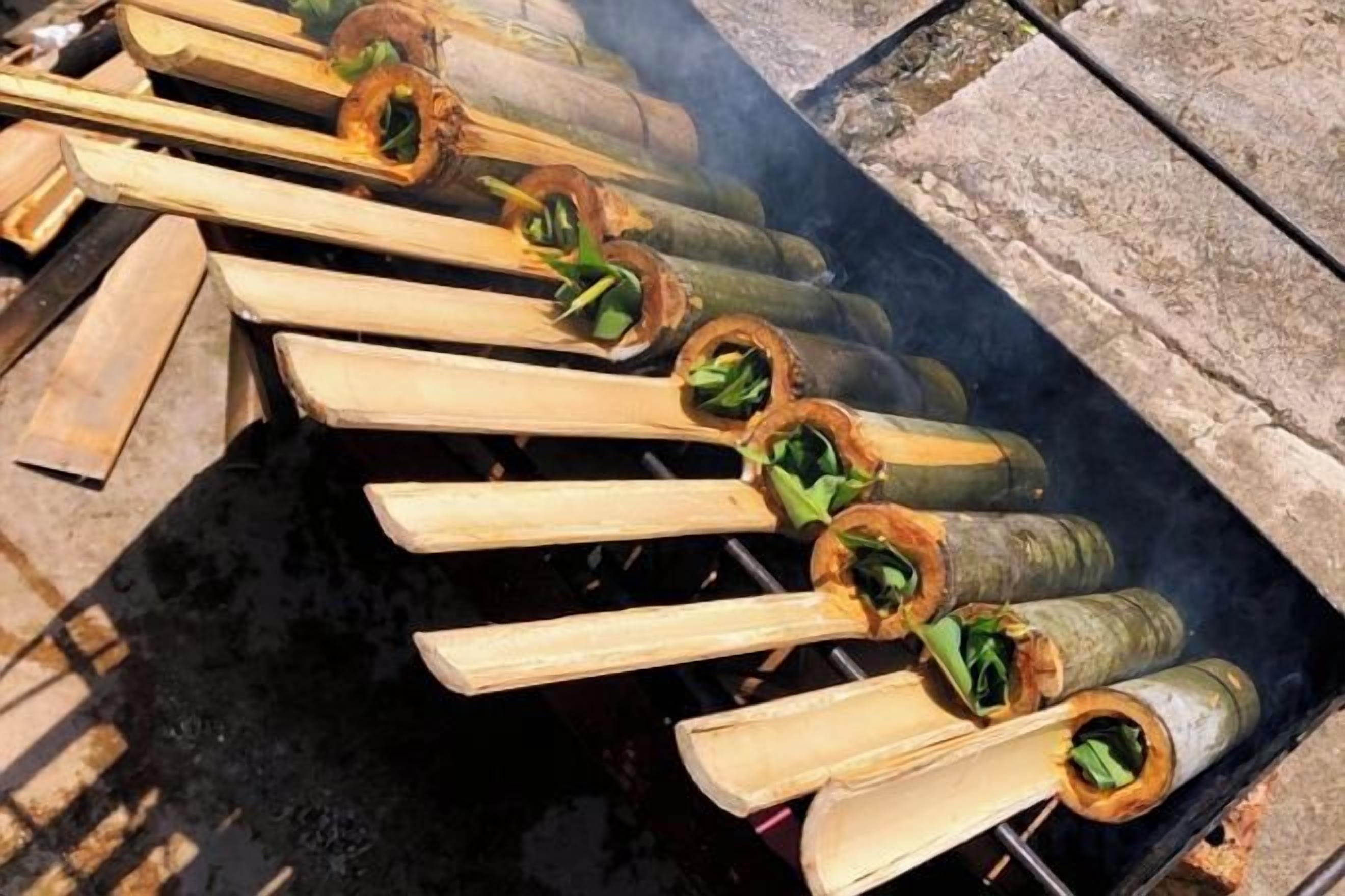 A grill with several skewers of food being cooked over an open flame.