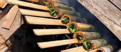 A grill with several skewers of food being cooked over an open flame.
