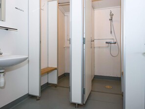 A bathroom with a sink, a shower, and a toilet. - 20 Person Holiday Home in Herning (Herning)