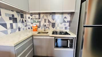 Comfort Apartment | Private kitchen | Full-sized fridge, microwave, oven, stovetop