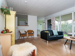 A room with a sofa, chairs, a table, and a large window. - 6 Person Holiday Home in Knebel (Knebel)