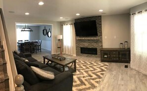 Cozy living space with a fireplace, flat-screen TV, and comfortable seating area.