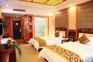 A hotel room with two beds, a desk, a chair, a nightstand, a telephone, and a decorative wall panel. - Jianfu Hotel (Chongqing)