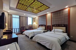 A hotel room with two beds, a TV, a desk, and a decorative ceiling. - Jianfu Hotel (Chongqing)