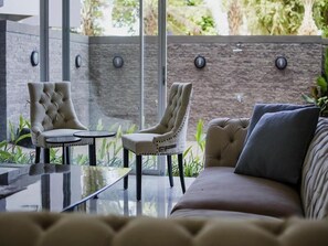 Relax in a stylish space with a sofa, armchairs, and a small table.