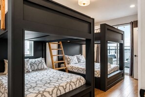 A room with two bunk beds, a ladder, and a view of the outside. - Modern Nashville Home • Rooftop & Hot Tub (Nashville)