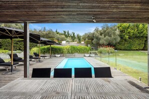 A wooden deck with a pool, lounge chairs, and umbrellas. - Portsea Sanctuary, Gas Heated Pool & Gardens (Portsea)