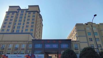 A multi-story building with a prominent entrance and signage.